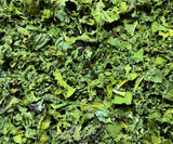 Dehydrated Trio Kale Greens for parrots made with Green Kale, Lacinato Kale, and Red Scarlet Kale, dried into crunchy greens that can be served as a treat, mixed into seed, pellets, chop, or used as a food topper. Close Up of actual product